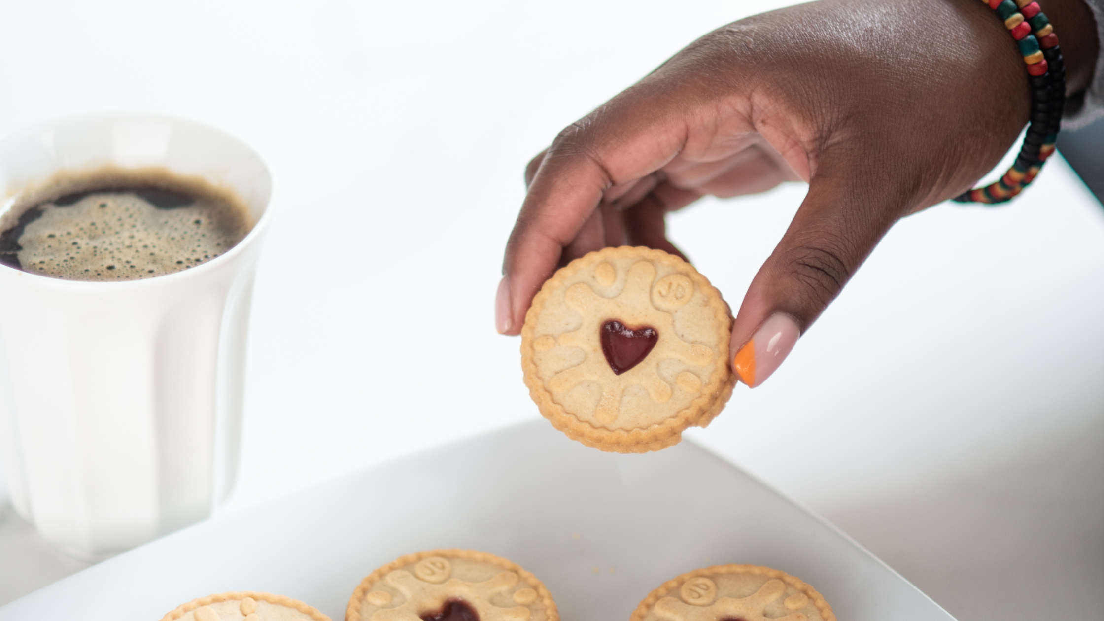 Black female picking up a biscuit